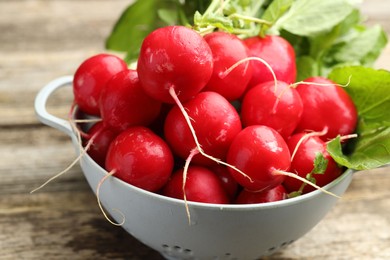Photo of Many fresh radishes on wooden table, closeup