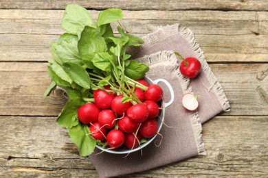 Photo of Many fresh radishes on wooden table, top view