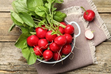 Photo of Many fresh radishes on wooden table, top view