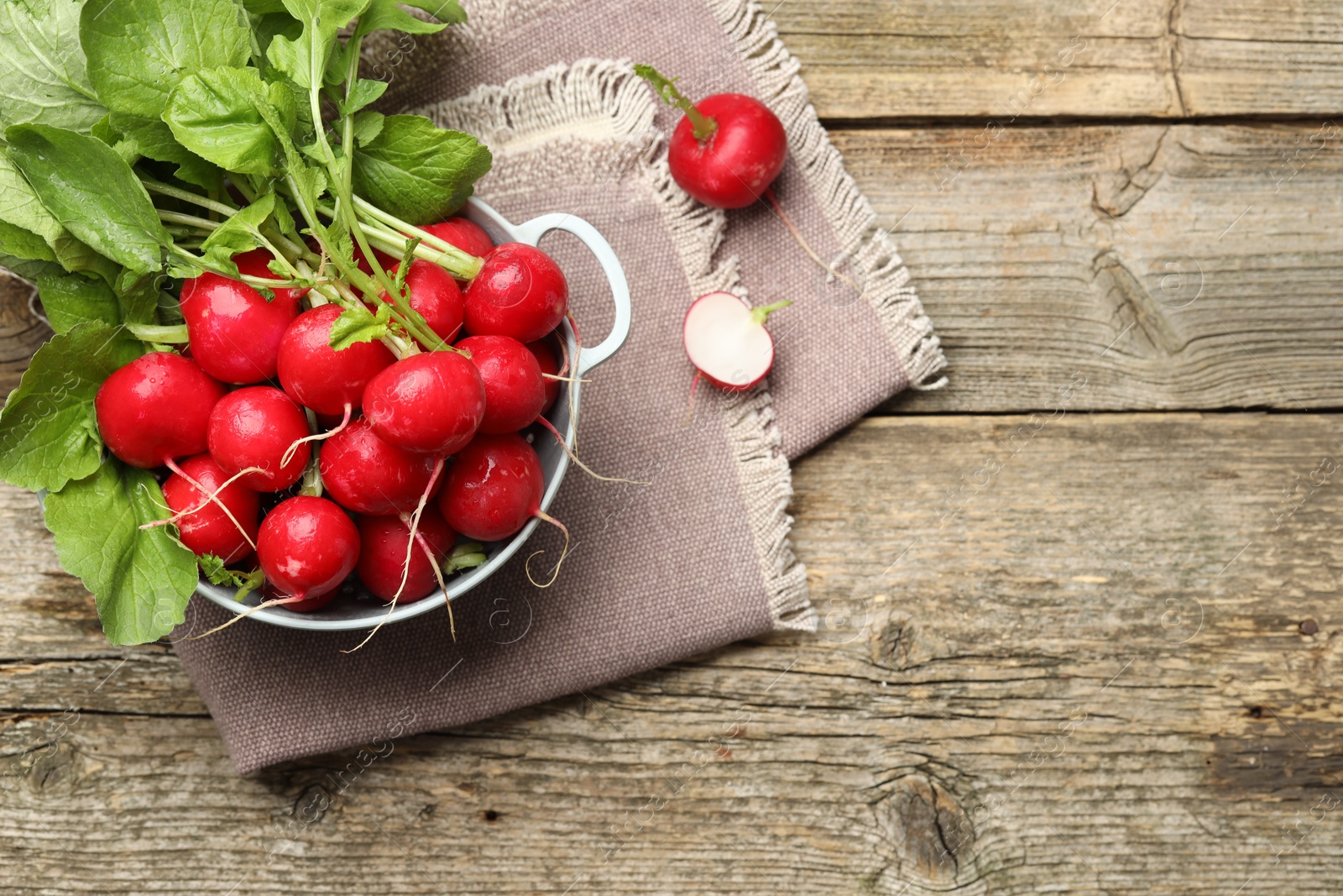 Photo of Many fresh radishes on wooden table, top view. Space for text