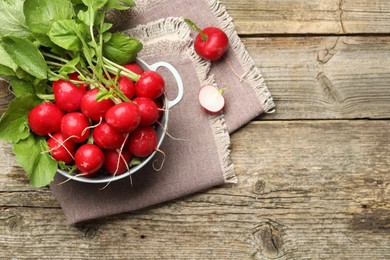 Photo of Many fresh radishes on wooden table, top view. Space for text