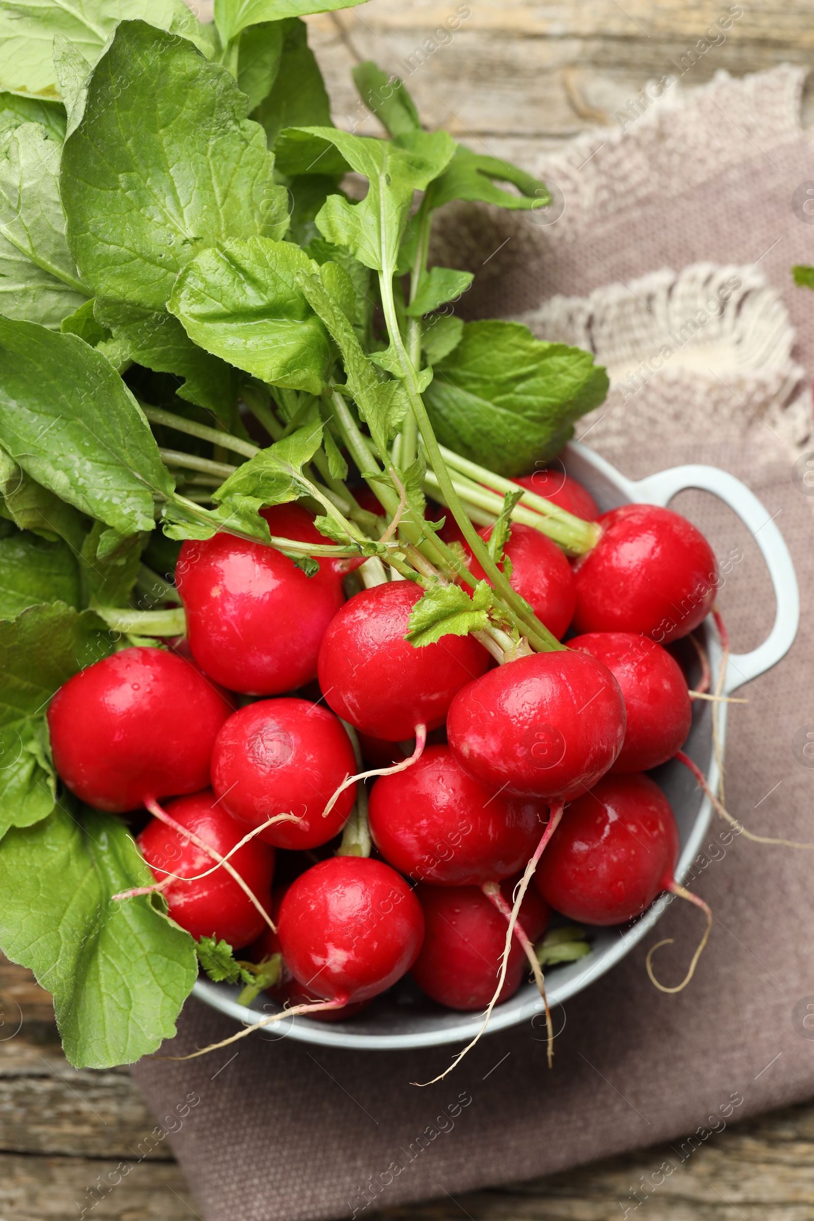 Photo of Many fresh radishes on wooden table, top view