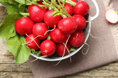 Photo of Many fresh radishes on wooden table, top view