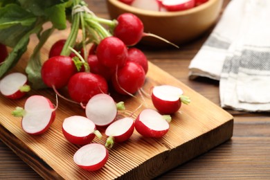 Photo of Fresh cut and whole radishes on wooden table, closeup