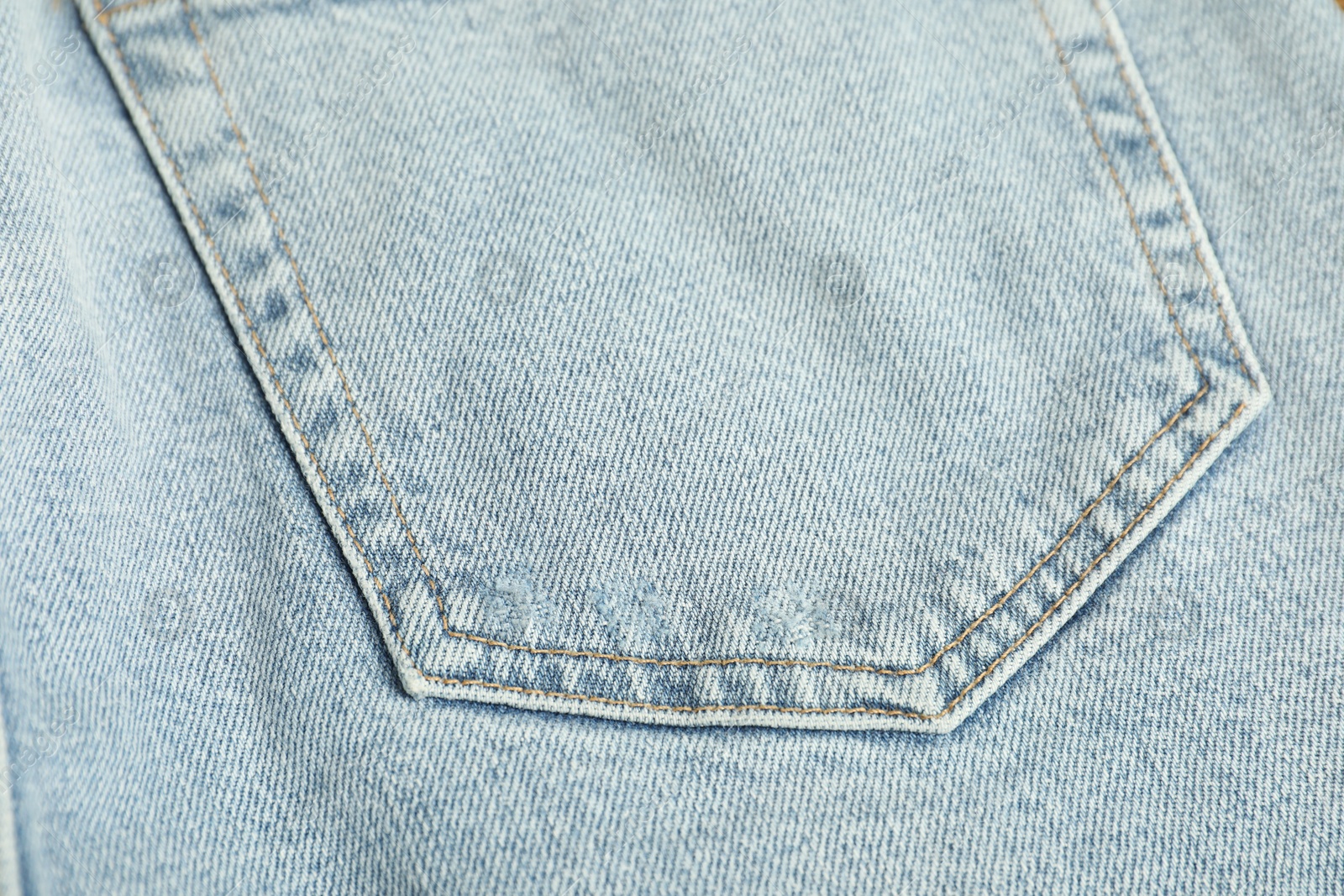 Photo of Stylish light blue jeans with pocket as background, top view