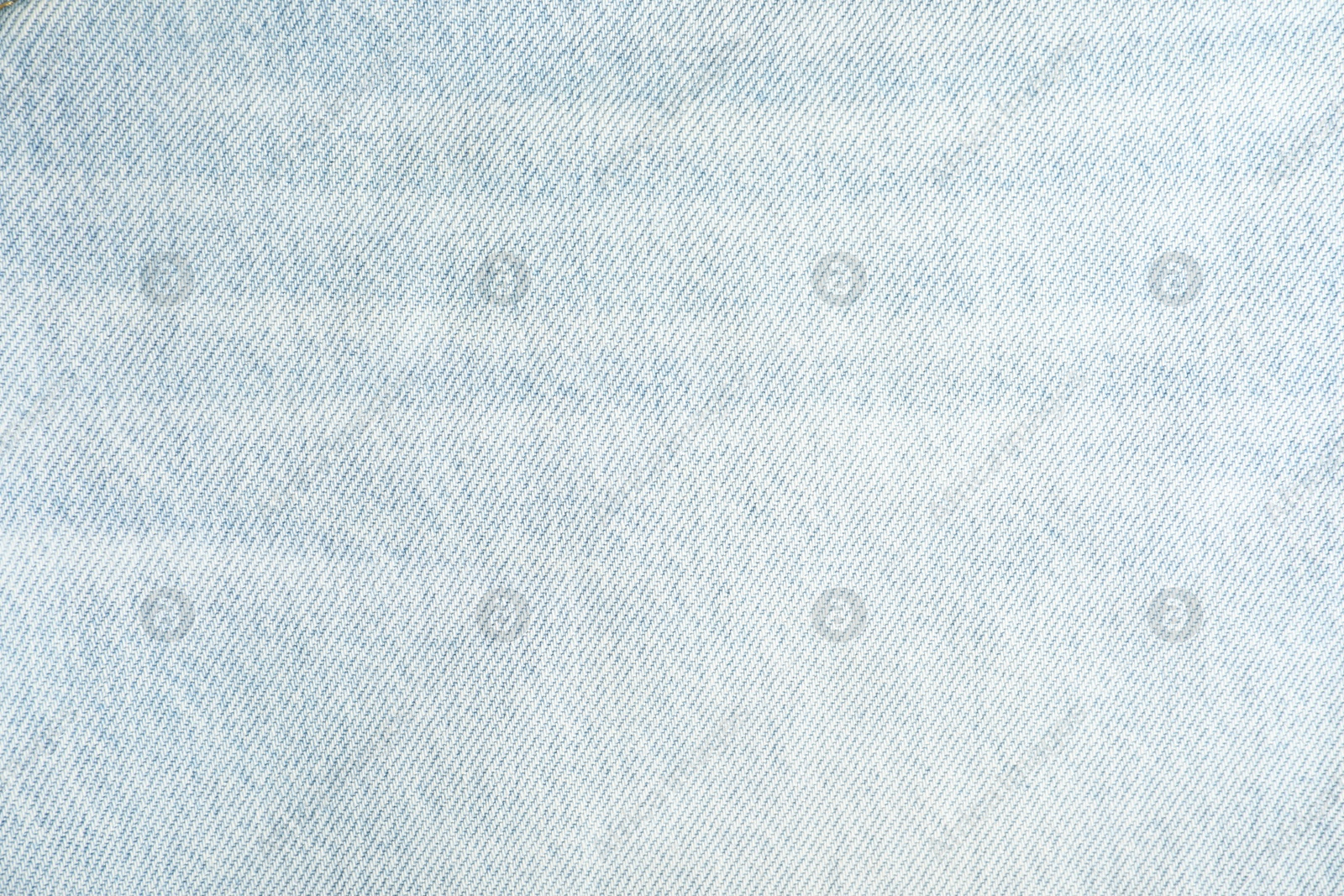 Photo of Texture of light blue jeans as background, top view