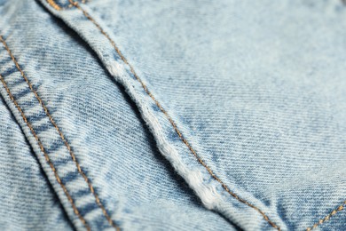 Photo of Stylish light blue jeans with pocket as background, closeup