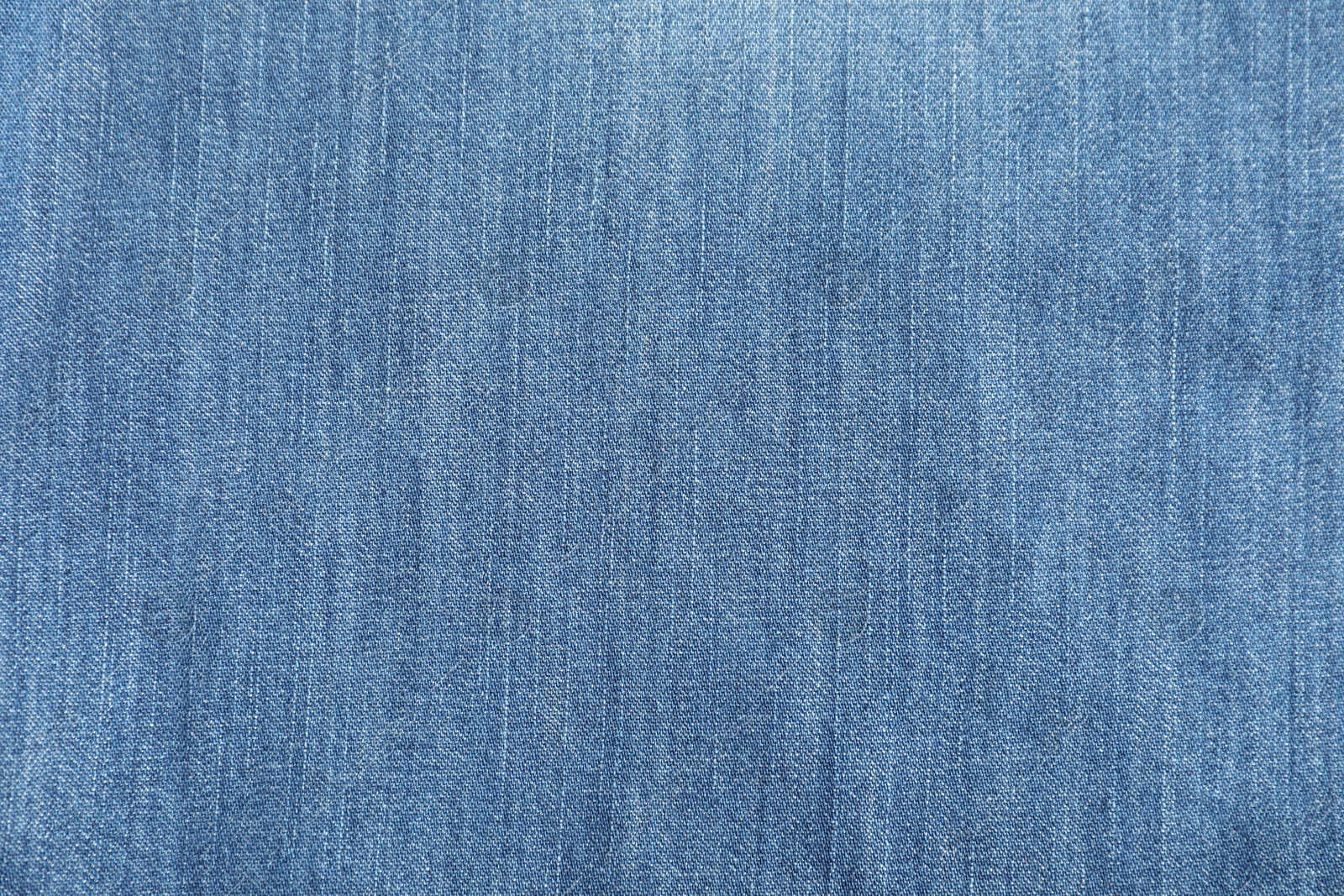 Photo of Texture of blue jeans as background, top view