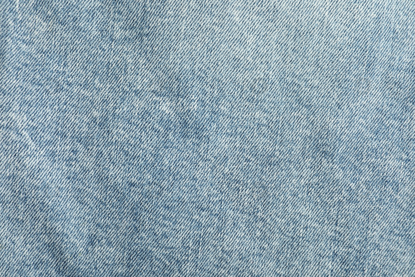 Photo of Texture of light blue jeans as background, top view