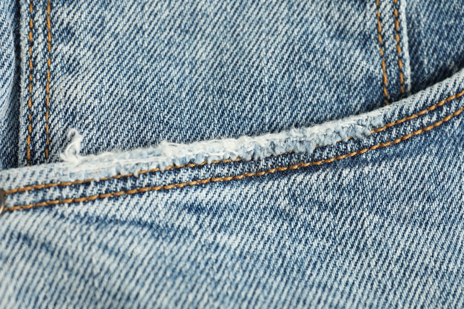 Photo of Stylish light blue jeans with pocket as background, top view