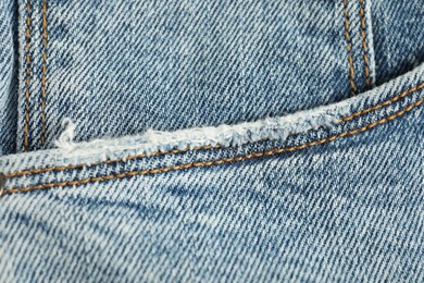 Photo of Stylish light blue jeans with pocket as background, top view