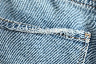 Photo of Stylish light blue jeans with pocket as background, top view