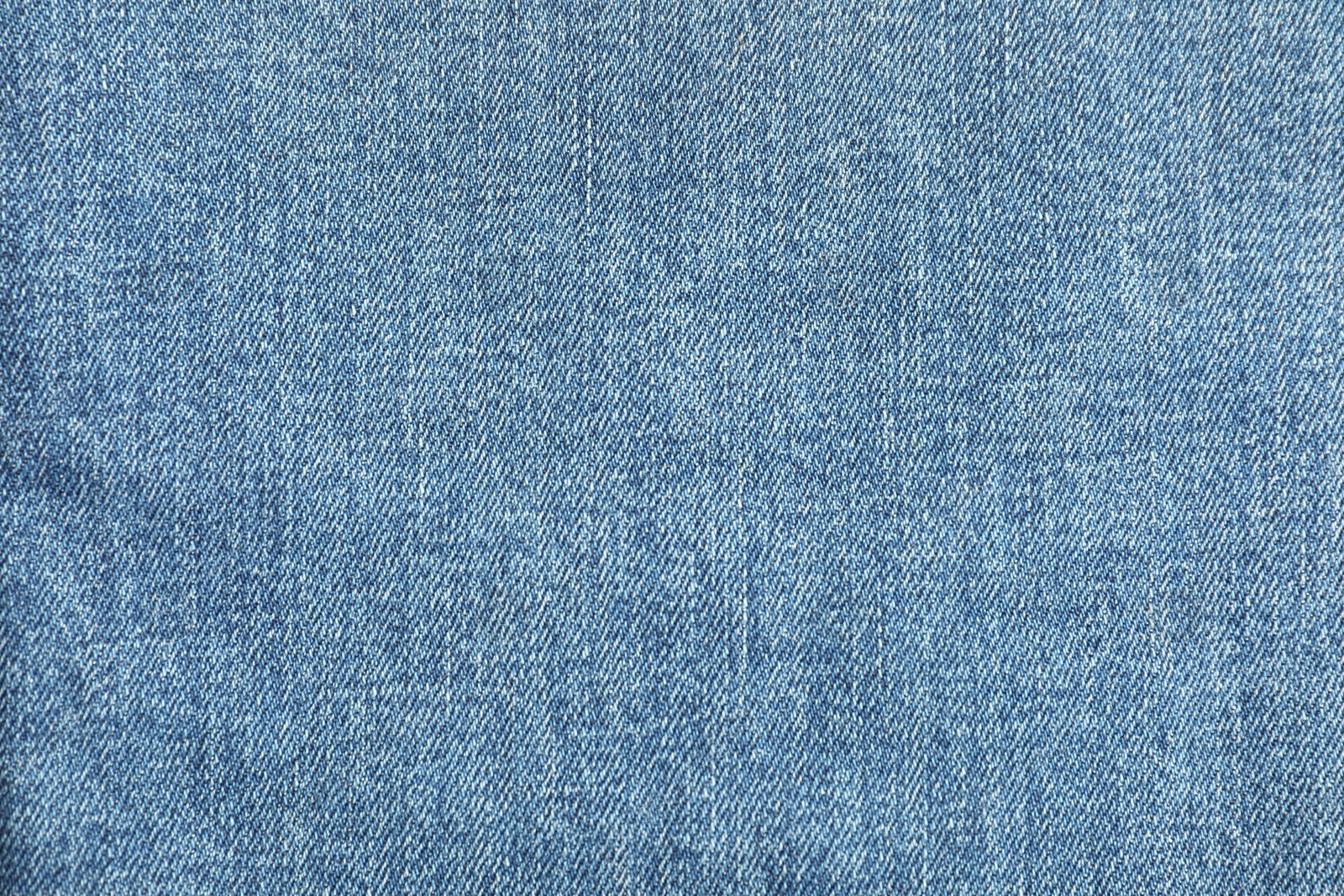 Photo of Texture of blue jeans as background, top view