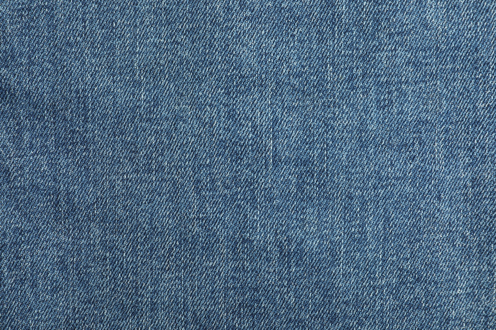 Photo of Texture of blue jeans as background, top view