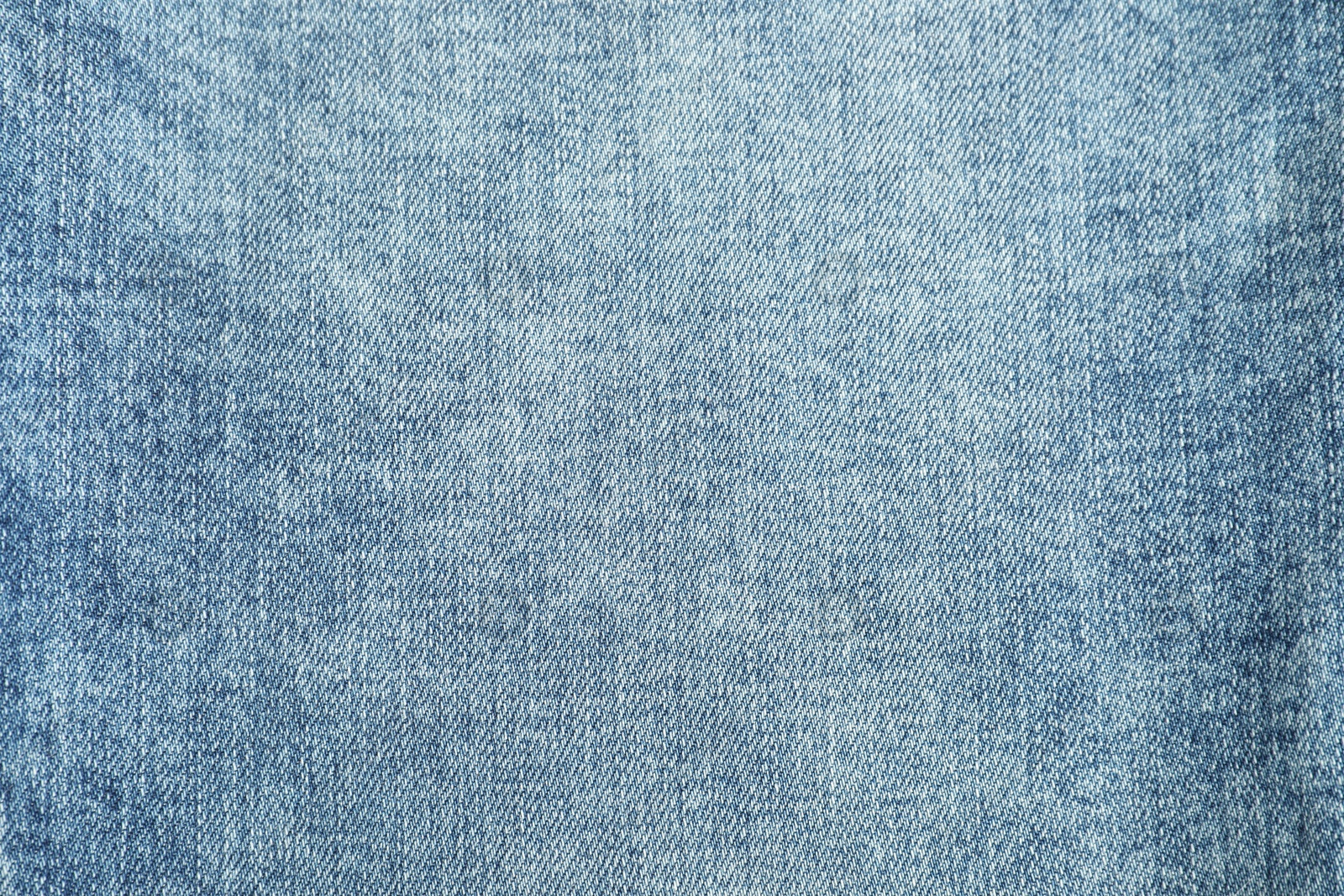 Photo of Texture of blue jeans as background, top view