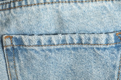 Photo of Stylish light blue jeans with pocket as background, top view