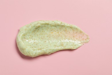 Photo of Smear of body scrub on pink background, top view