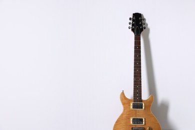 Photo of One modern electric guitar on white background. Space for text