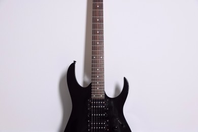 Photo of One modern electric guitar on white background