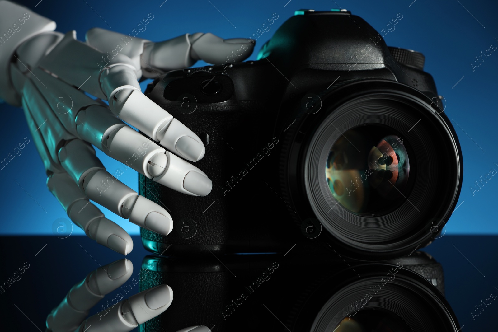 Photo of Artificial intelligence. Robot hand with photo camera against dark blue background, closeup