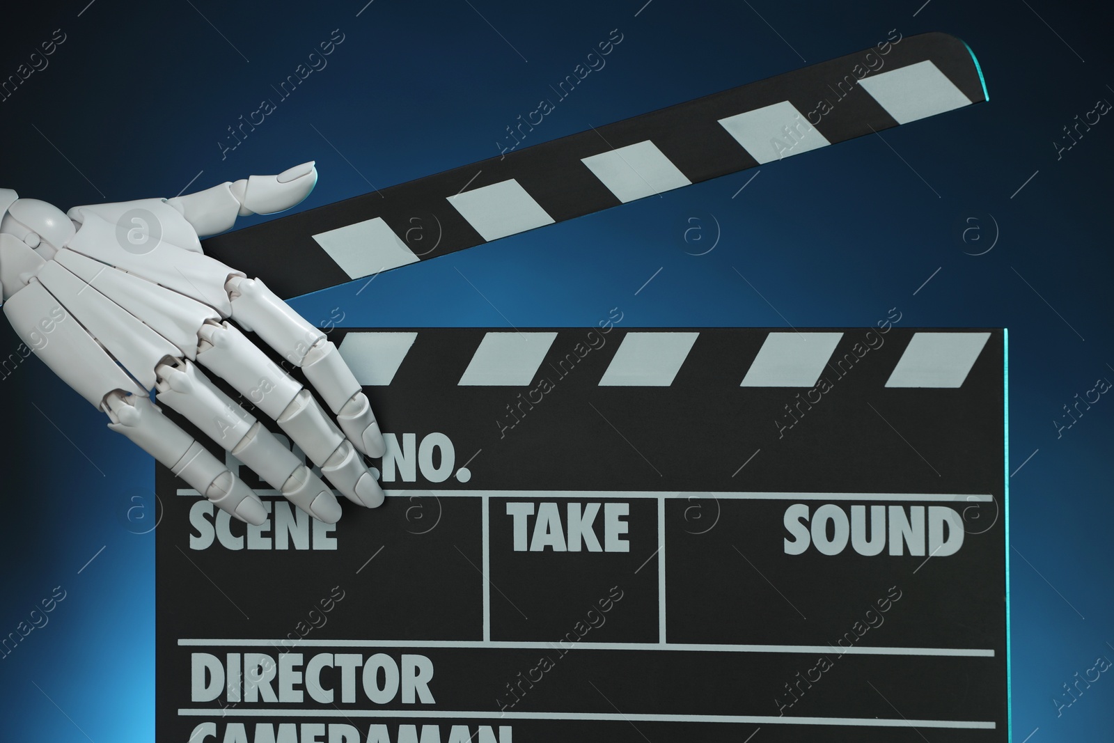 Photo of Artificial intelligence. Robot hand with clapper against dark blue background, closeup