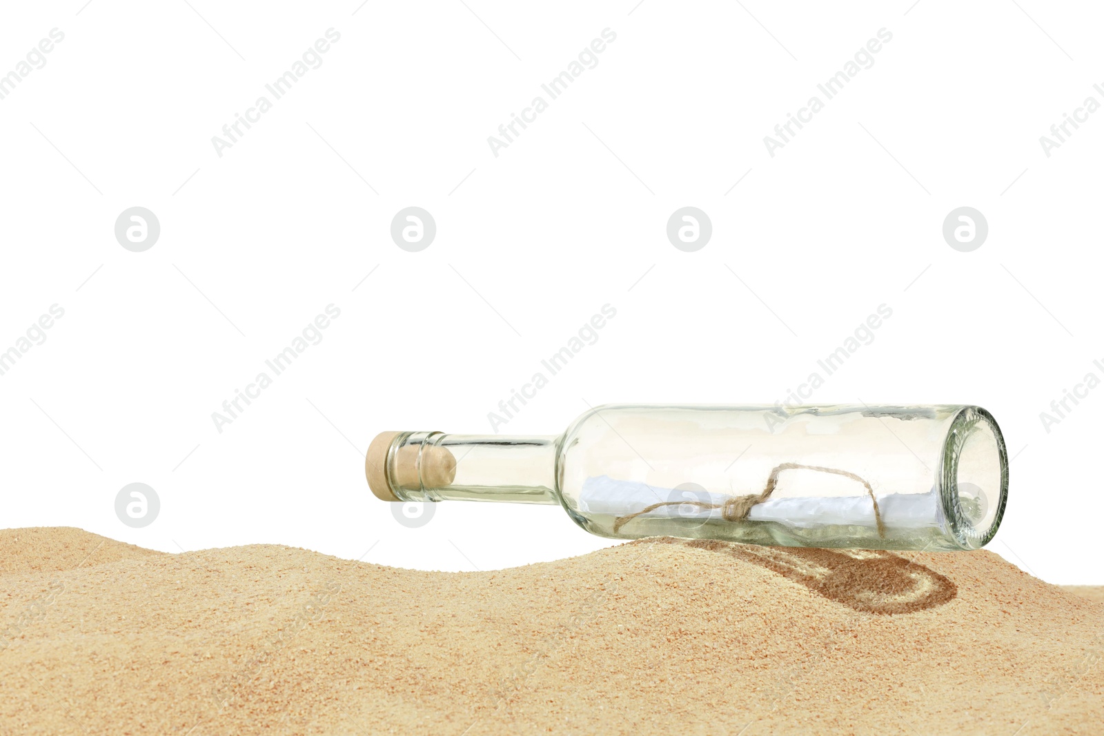 Photo of Rolled letter in corked glass bottle on sand against white background