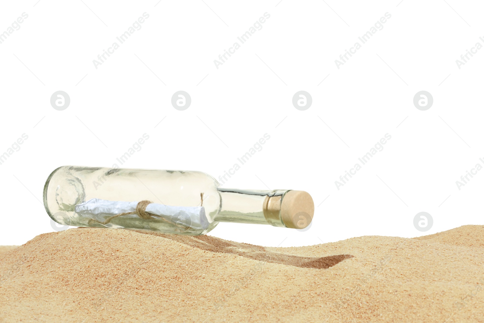 Rolled letter in corked glass bottle on sand against white background Photo of Rolled letter in corked glass bottle on sand against white background