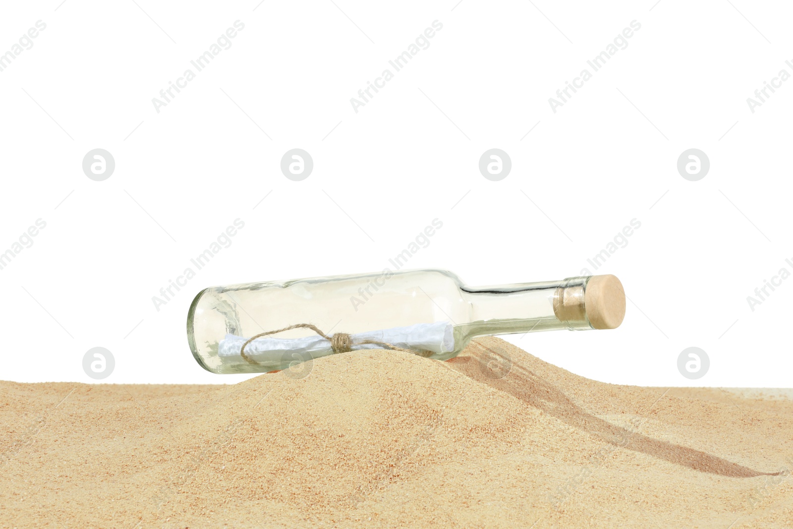 Photo of Rolled letter in corked glass bottle on sand against white background