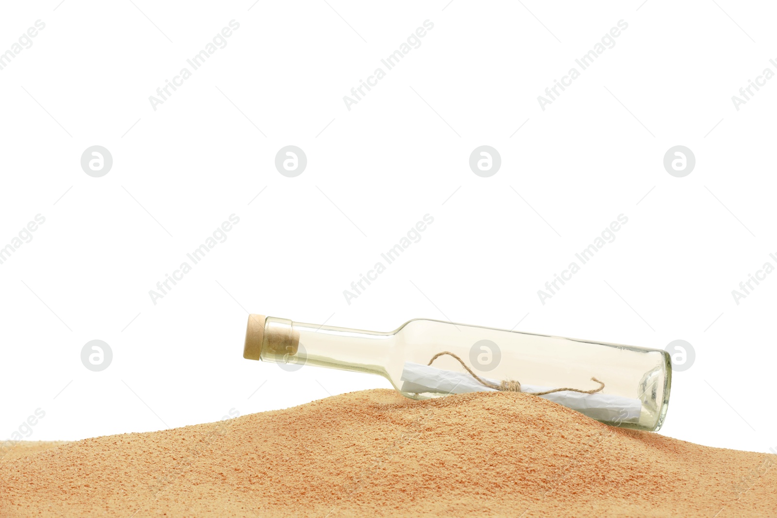 Photo of Rolled letter in corked glass bottle on sand against white background