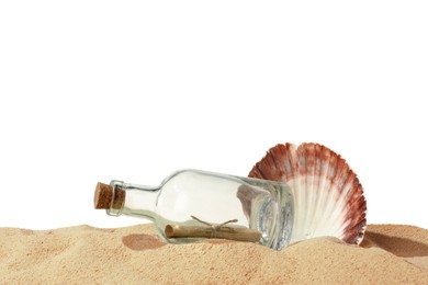 Photo of Rolled letter in corked glass bottle and shell on sand against white background