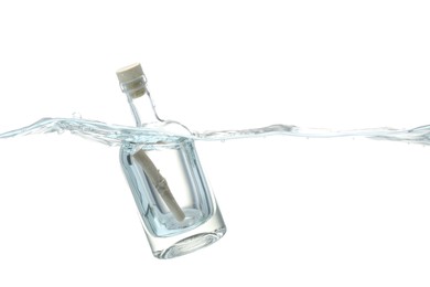 Photo of Corked glass bottle with rolled letter in water on white background