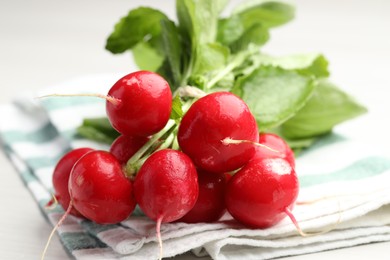 Photo of Bunch of fresh radishes on white table, closeup