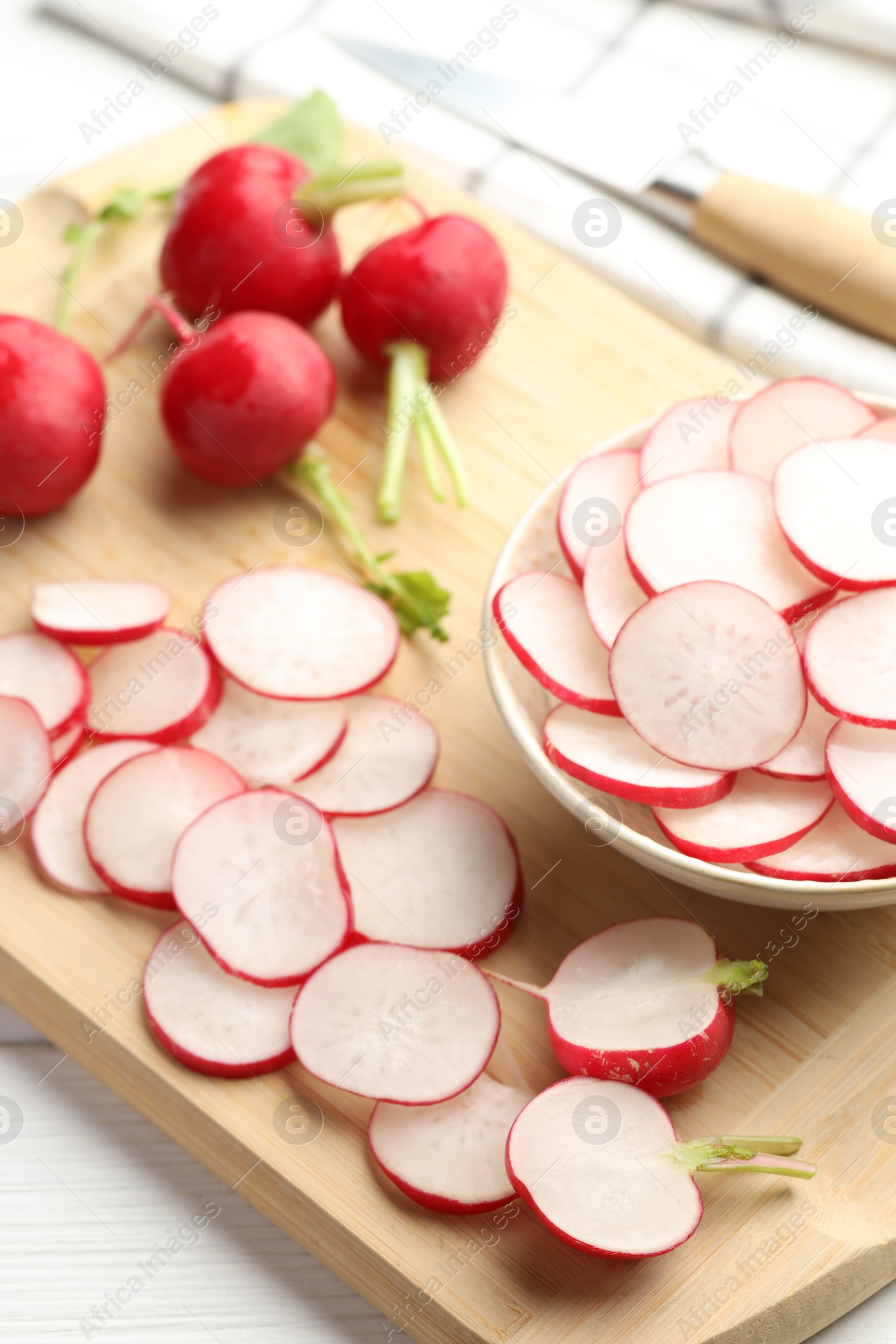 Fresh whole and cut radishes on white wooden table, above view Photo of Fresh whole and cut radishes on white wooden table, above view