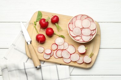 Photo of Many fresh radishes and knife on white wooden table, top view