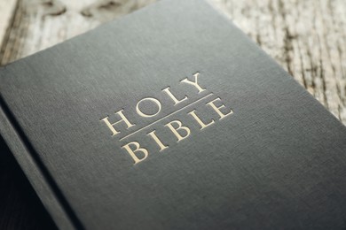 Photo of Hardcover Holy Bible on table, closeup view