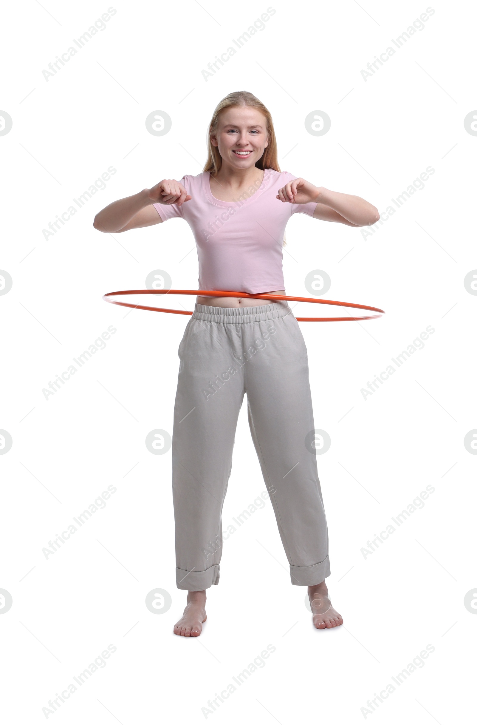 Photo of Beautiful young woman exercising with hula hoop on white background