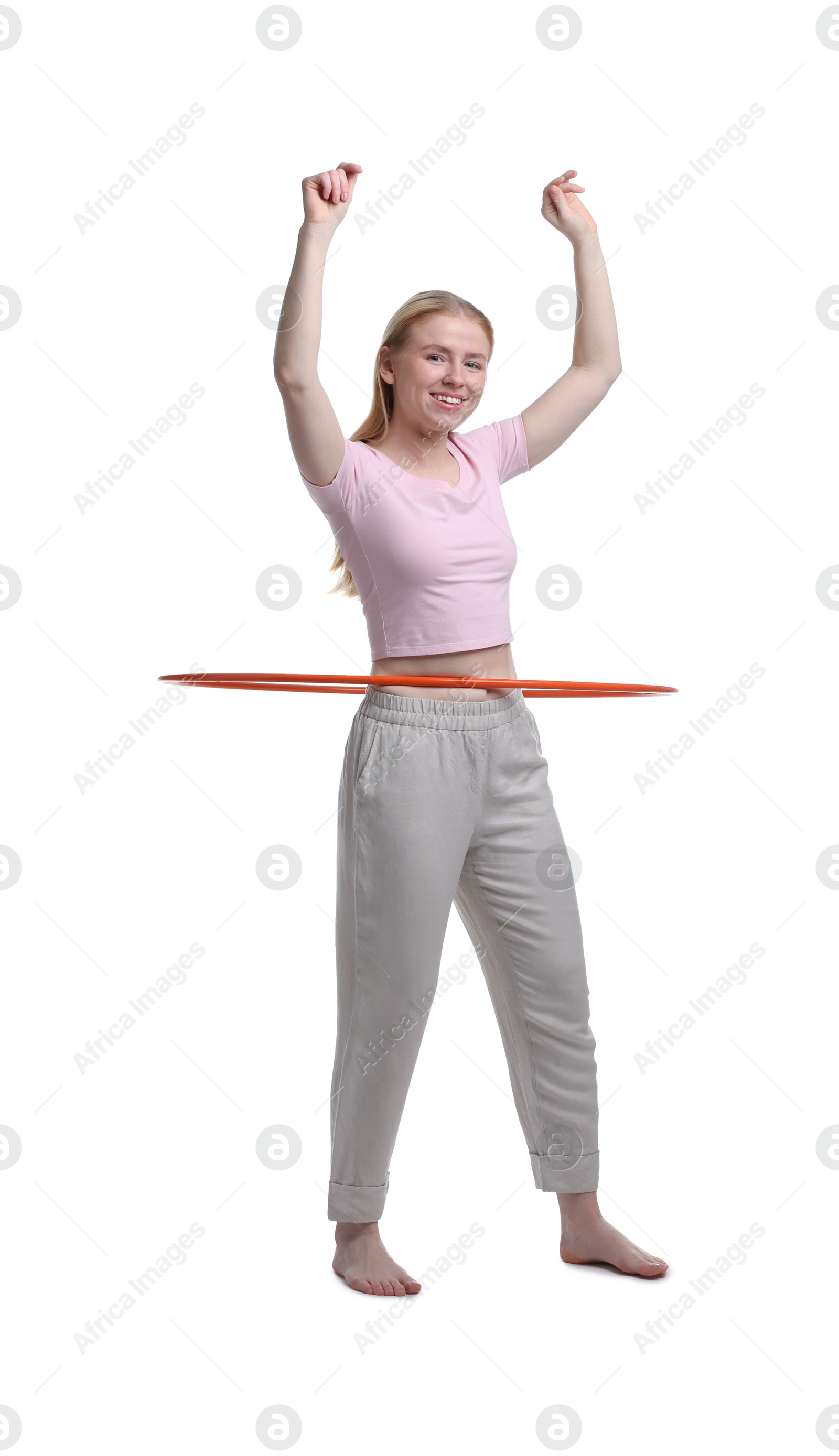 Photo of Beautiful young woman exercising with hula hoop on white background