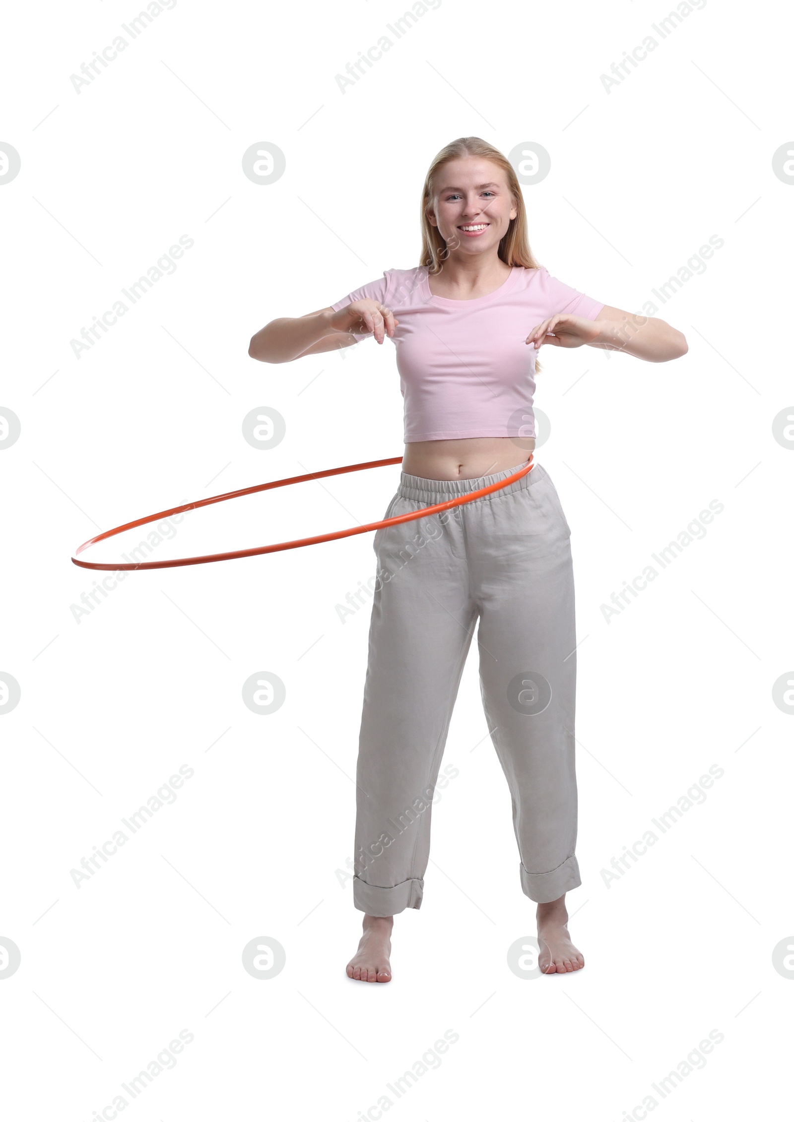 Photo of Beautiful young woman exercising with hula hoop on white background