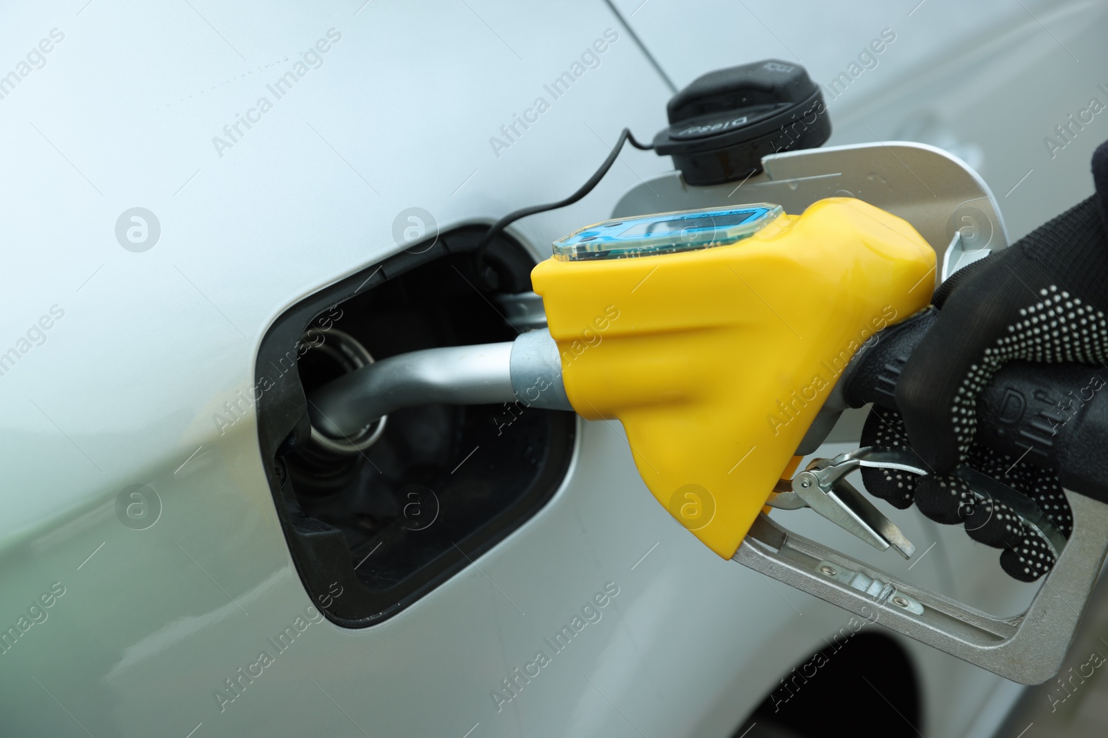 Photo of Man refueling his car at gas station, closeup