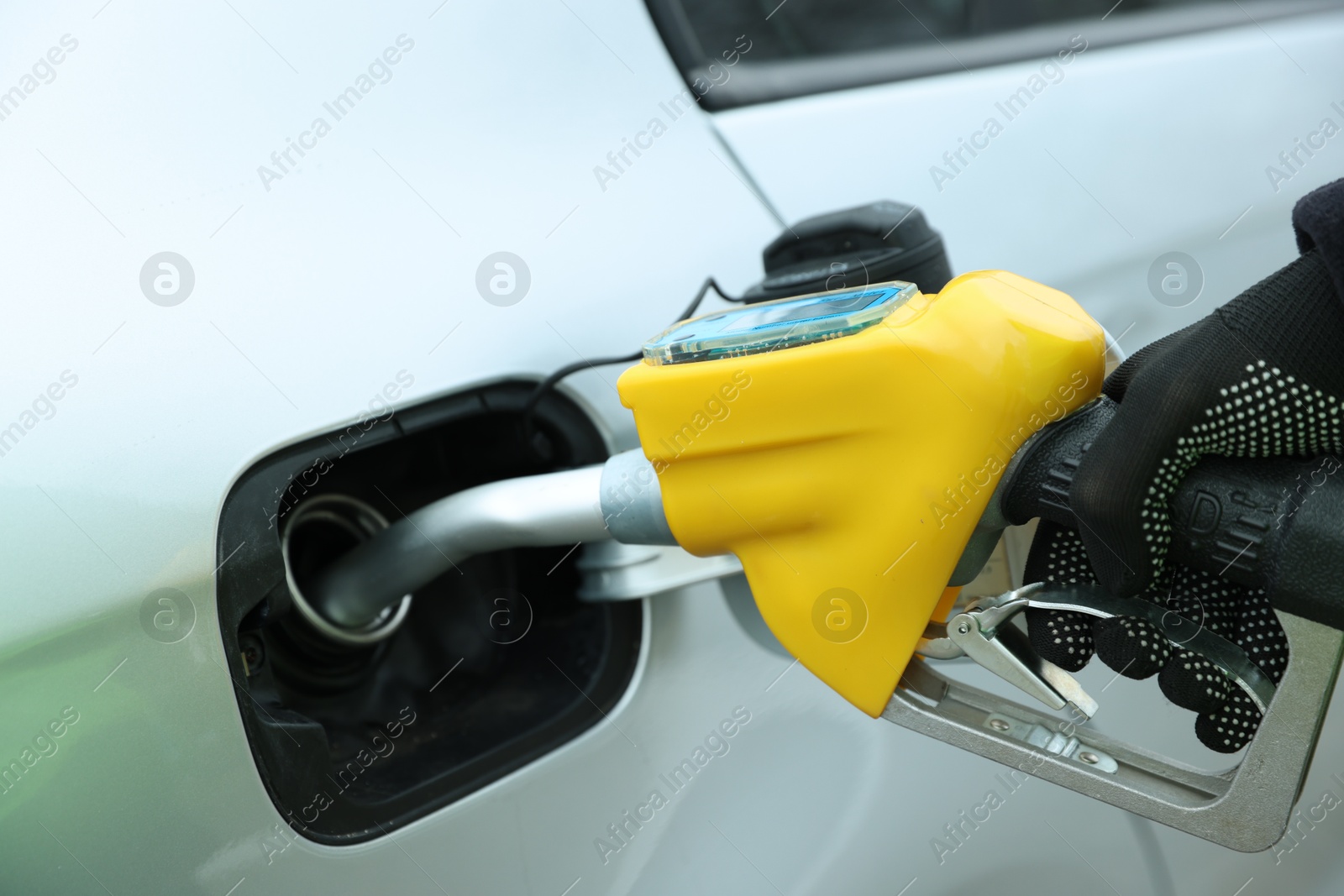 Photo of Man refueling his car at gas station, closeup