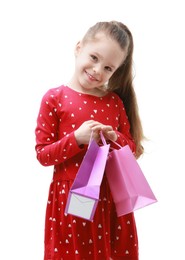 Happy little girl with shopping bags on white background