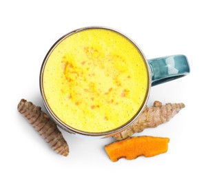 Photo of Tasty turmeric latte in cup and roots isolated on white, top view