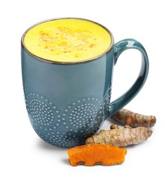 Photo of Tasty turmeric latte in cup and roots isolated on white