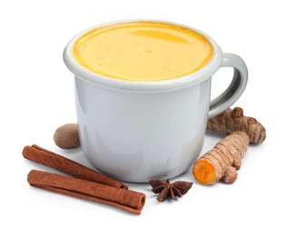 Photo of Tasty turmeric latte in cup and spices isolated on white