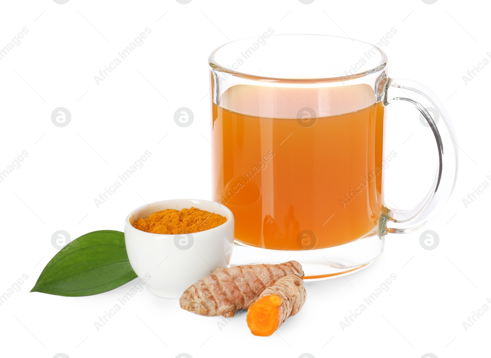 Photo of Aromatic turmeric tea in glass cup, roots, powder and green leaf isolated on white