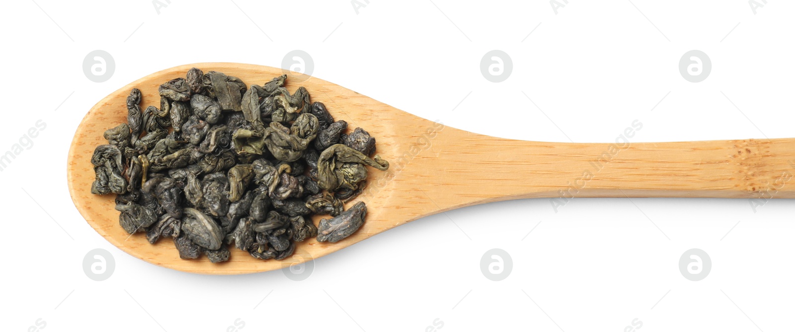 Photo of Dry tea leaves in wooden spoon isolated on white, top view