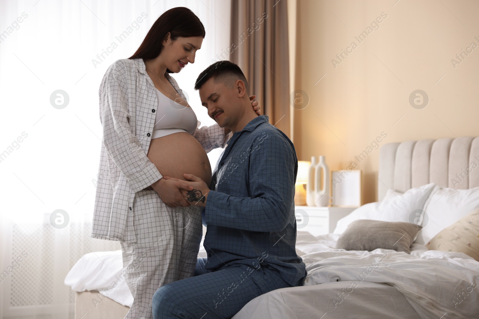 Photo of Pregnant woman and her husband at home