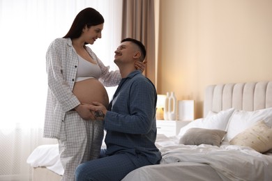 Photo of Pregnant woman and her husband at home