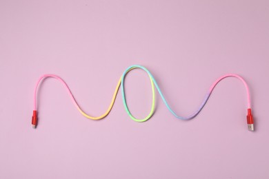 Photo of USB charge cable on pink background, top view