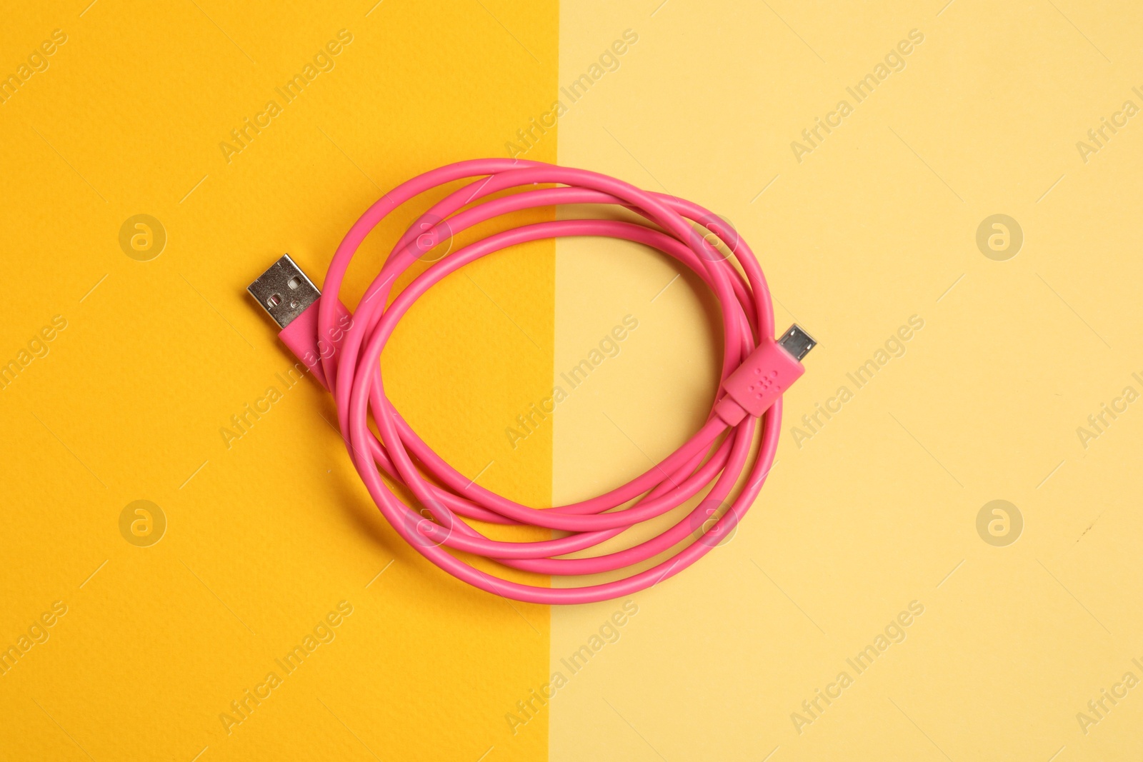 Photo of One USB charge cable on color background, top view